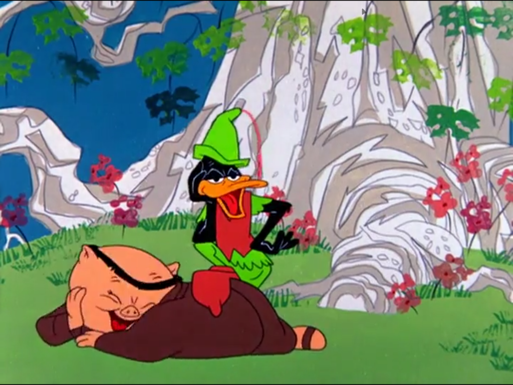 Daffy Duck in a green cap and vest stands over a reclining Porky Pig in a forest setting.