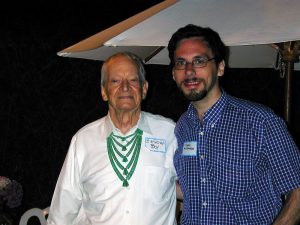 Maurice Noble wearing a green necklace and a Birthday Boy name tag with Harry McCracken